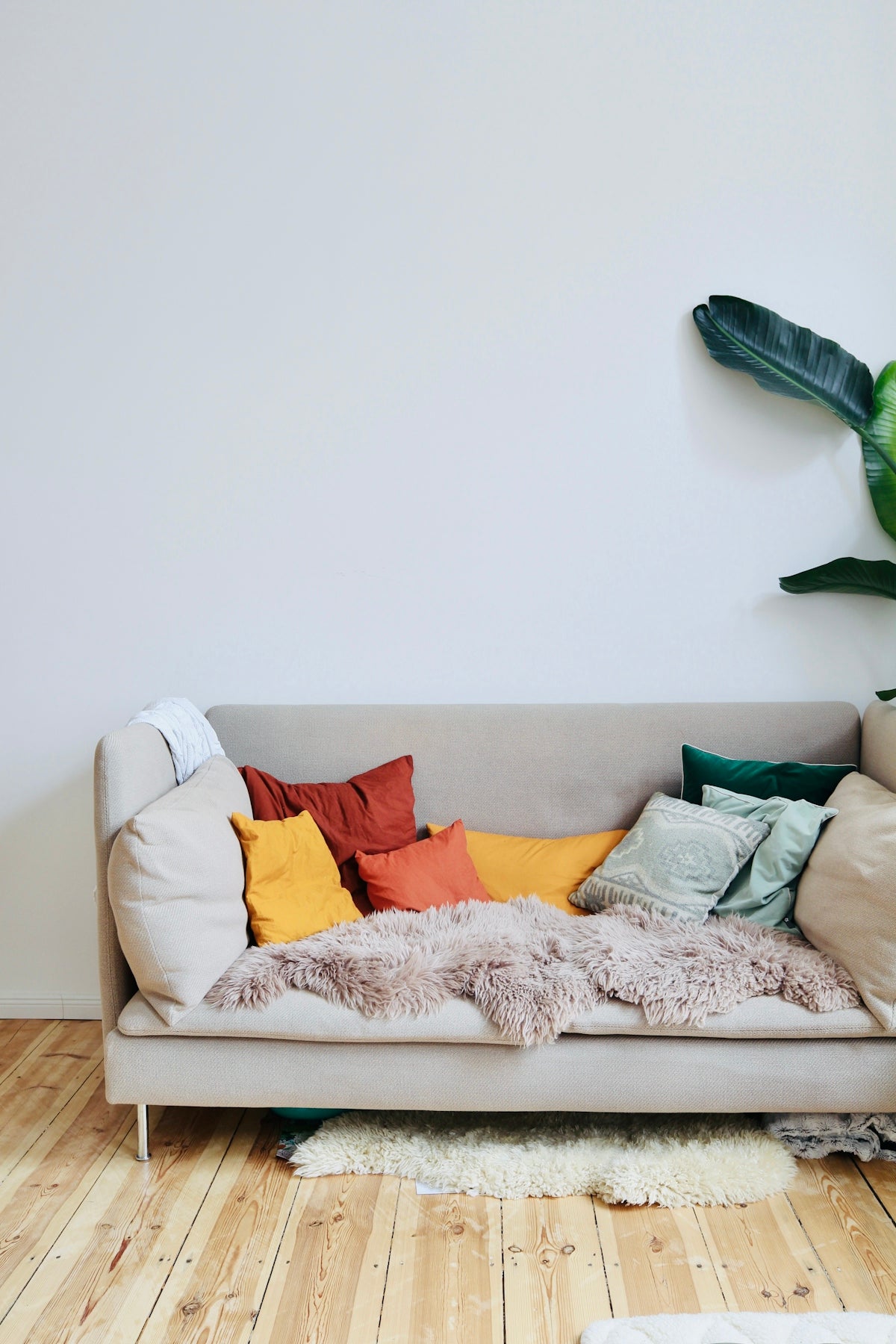 orange throw pillows on white couch