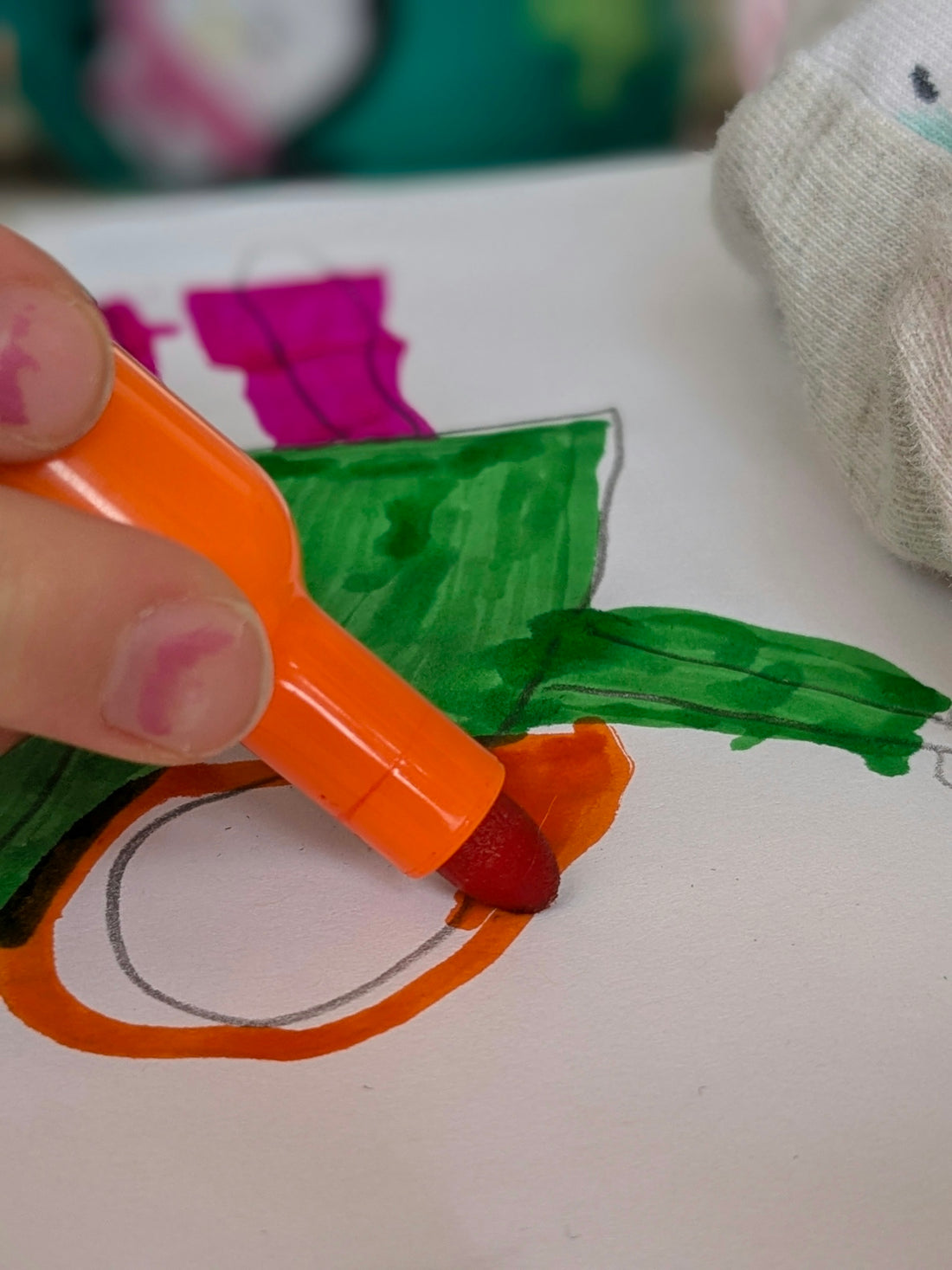 Someone is coloring with an orange marker.